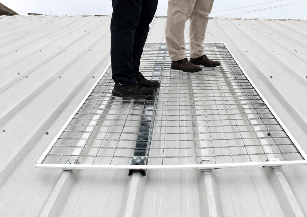 Workers Standing on Rooftop Safety Grating